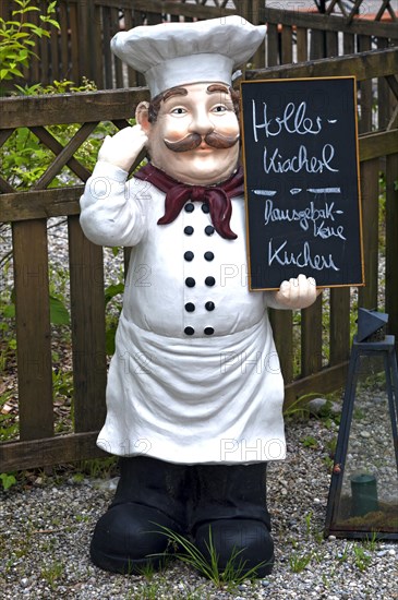 Chef figure with menu board