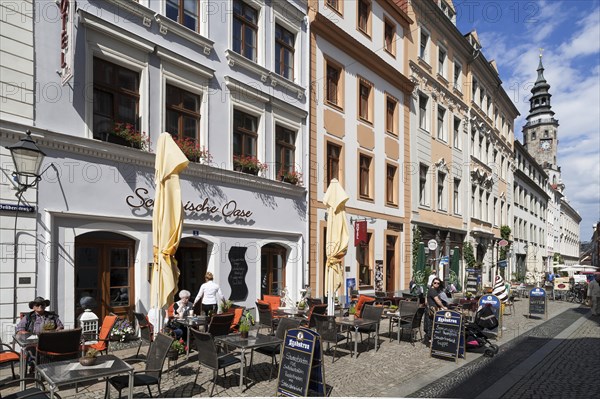 Pedestrian street with cafes and view of old town hall tower