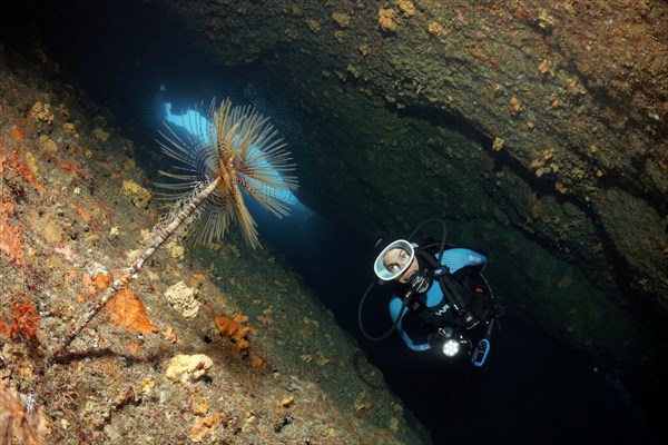 Diver in a cave with lamp