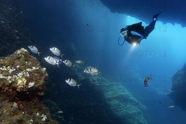 Diver in a cave with a lamp