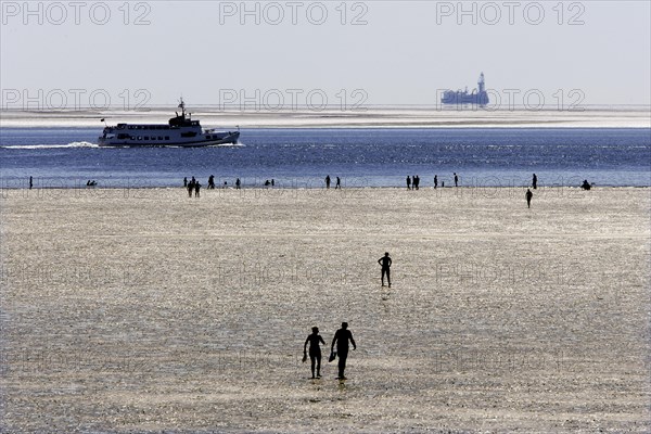 Strollers walking at low tide on the foreshore