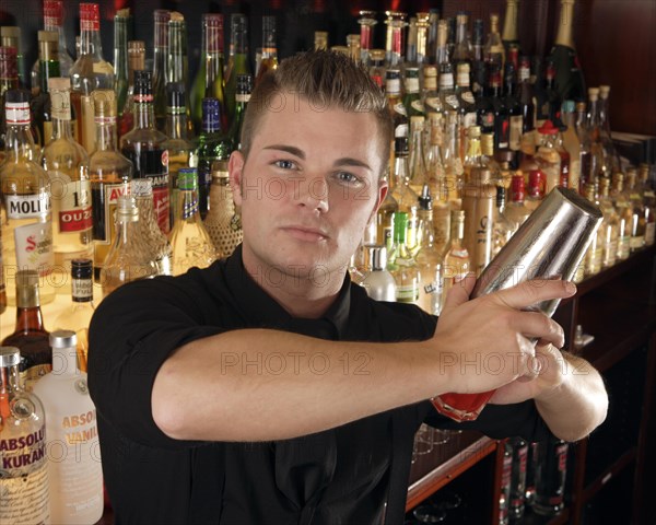 Barman mixing cocktail in a cocktail bar