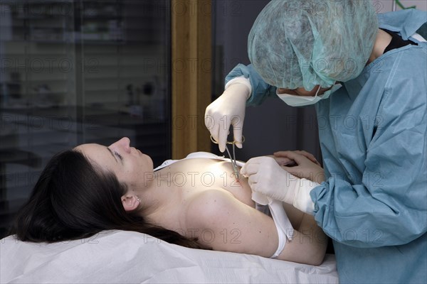 Patient and dermatologist during surgery