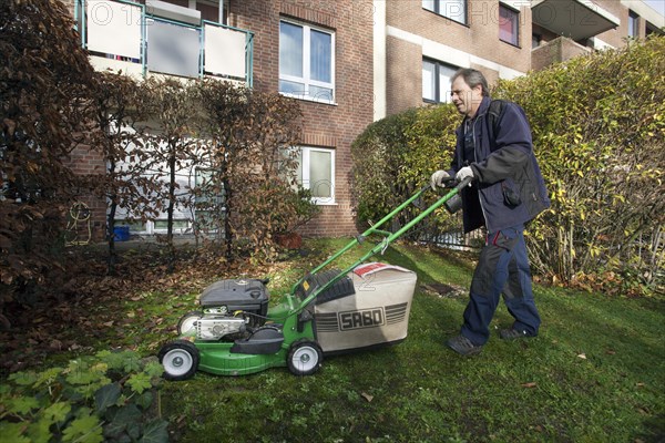 Janitor with mowing lawn lawnmower