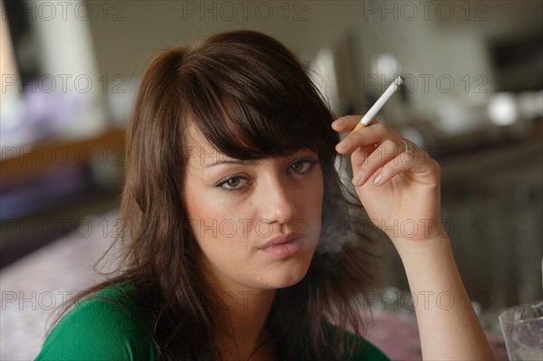 Young woman smoking in a bar or bistro