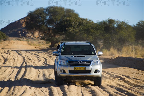 SUV driving on sandy road in south