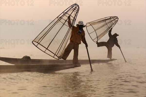 Fishermen rowing with one leg