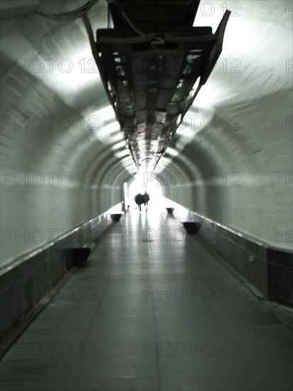 Passers-by in a tunnel