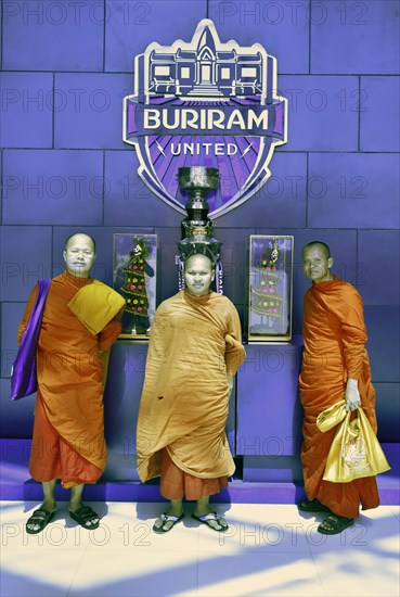 Monks posing in front of the Master Cup of Buriram United