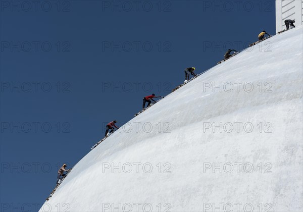 A group of climbers paint Ruwanwelisaya or Ruwanweli Maha Seya Stupa