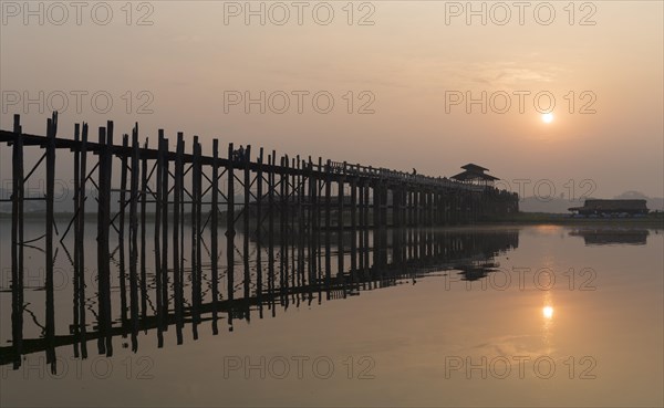 Sunrise over the U Bein Bridge crossing the Taungthaman Lake