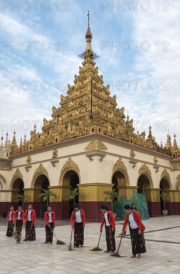 Burmese women sweep the floor around the Mahamuni Paya temple in Mandalay