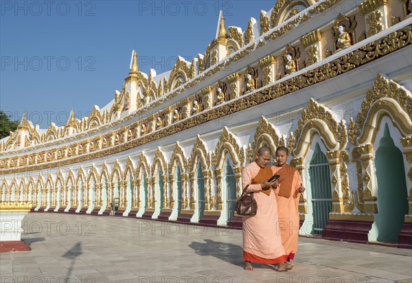 Buddhist monks in front of the curved chamber of Umin Thounzeh