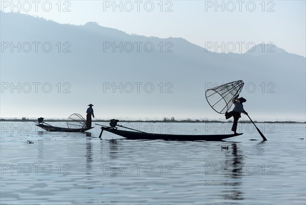 Intha fisherman fishing with traditional conical fishing net