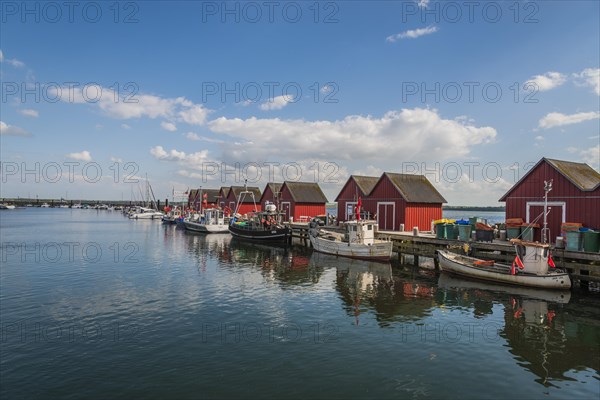 Red cottage with fishing boats