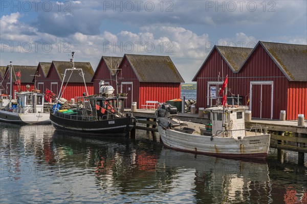 Red cottage with fishing boats