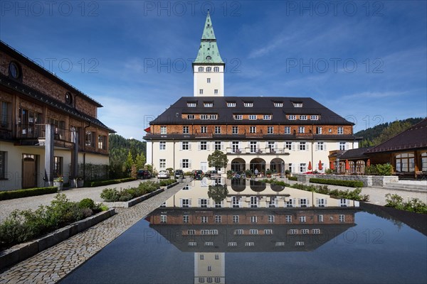 Schloss Elmau castle hotel with tower reflected in the fountain