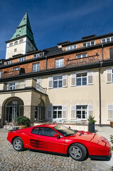 Ferrari in front of Schloss Elmau castle hotel