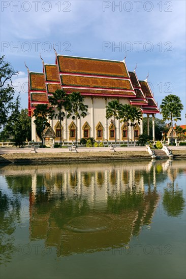South facade of the Wat Klang temple reflected in a pond