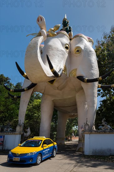 Taxi passing the gate of the three-headed elephant Erawan