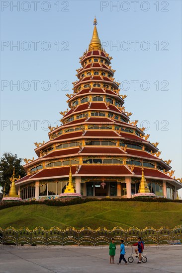 Children playing in front of the nine-story pagoda of the Wat Huay Pla Kang temple