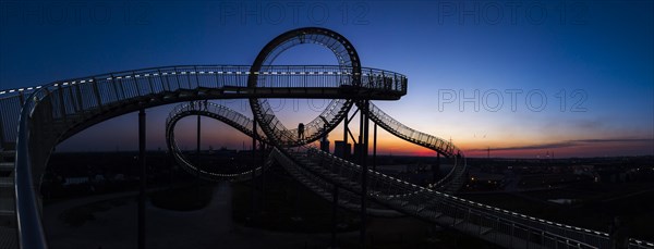 Power plant with part of the Tiger and Turtle sculpture at sunset