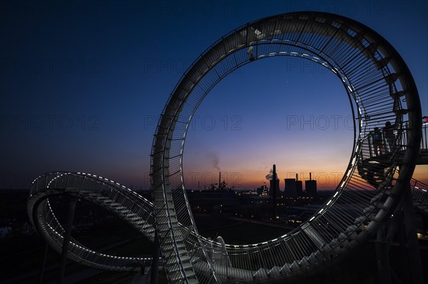 Power plant with part of the Tiger and Turtle sculpture at sunset