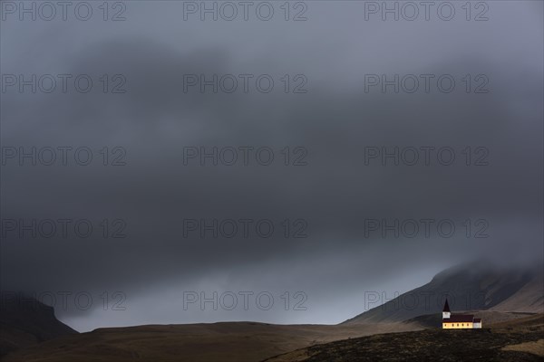 Vik i Myrdal church with mountains and fog