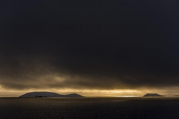 Sunset over Lake Pingvallavatn with mountaineous landscape