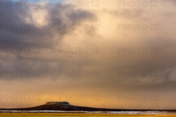 Volcanic cone with cloudy sky