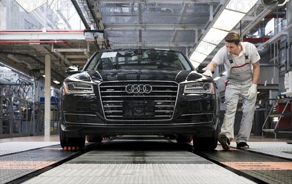 Audi AG employee conducting the first run of an assembled A8 sedan