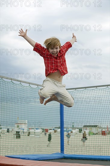 Boy jumping on trampoline