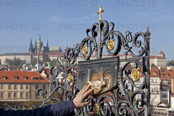Person touching a saint's depiction