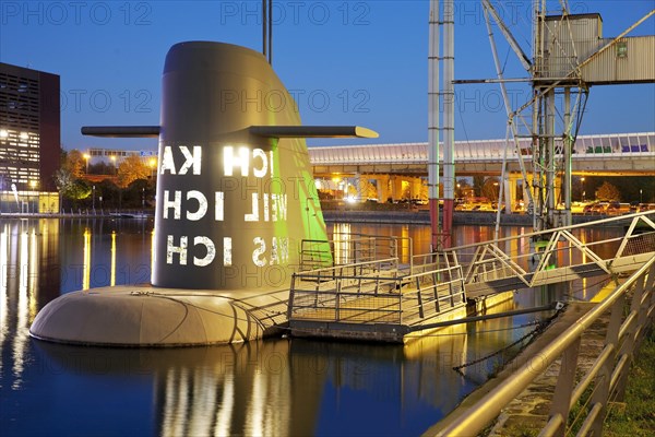 Work of art submarine island at the Kuppersmuhle Museum at dusk