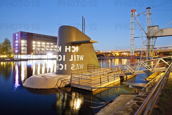 Work of art submarine island at the Kuppersmuhle Museum at dusk