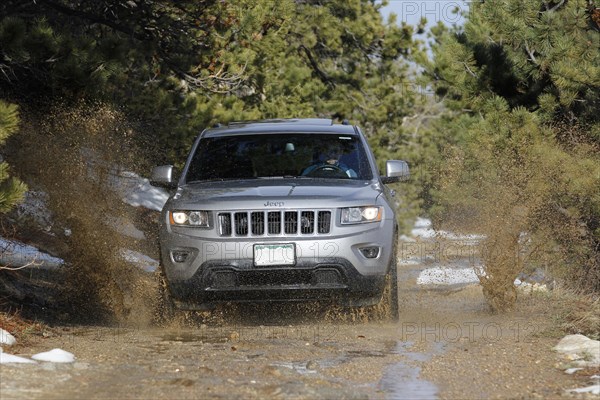 Jeep Grand Cherokee offroad in a large puddle