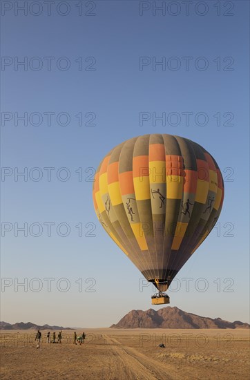 Hot-air balloon just taken-off in the early morning