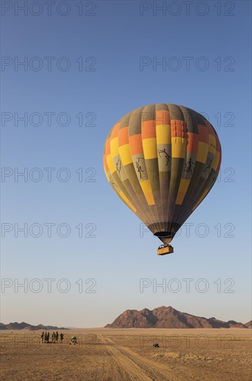 Hot-air balloon just taken-off in the early morning