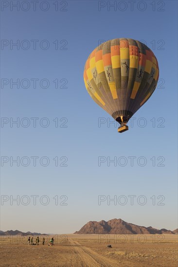 Hot-air balloon just taken-off in the early morning