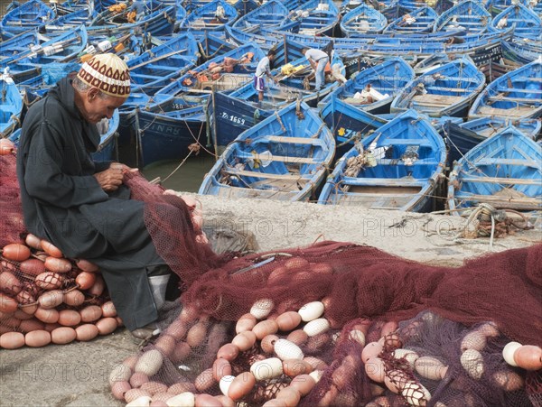 Man repairing fishing nets