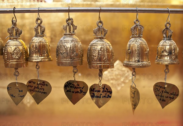 Golden bells hanging from a pole as an sacrifice