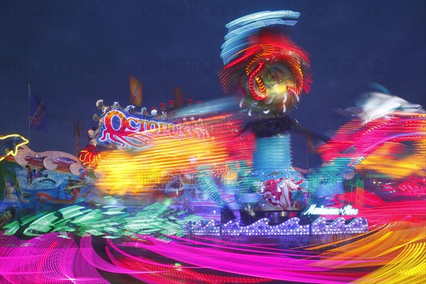 Octopussy ride on the fun fair Bremer Freimarkt at dusk