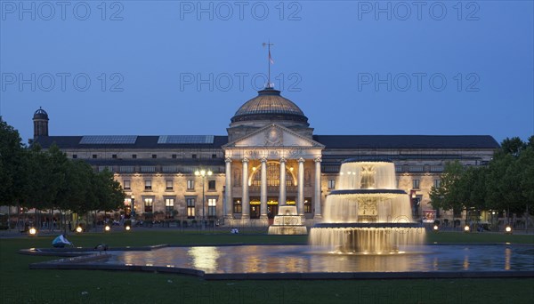 Spa hotel with fountain and park Bowling Green at dusk