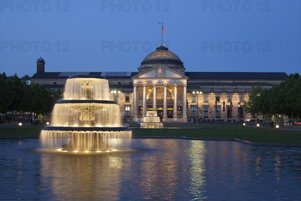 Spa hotel with fountain and park Bowling Green at dusk