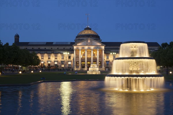 Spa hotel with fountain and park Bowling Green at dusk