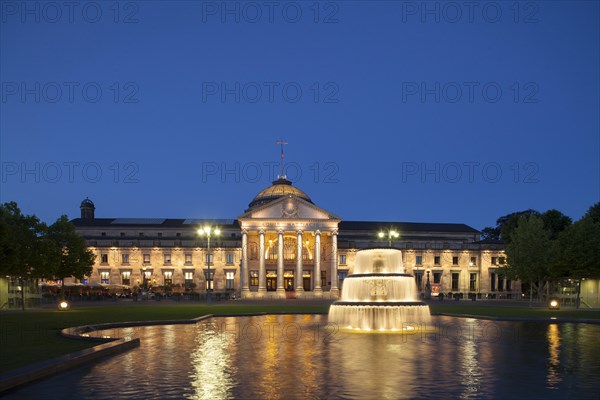 Spa hotel with fountain and park Bowling Green at dusk