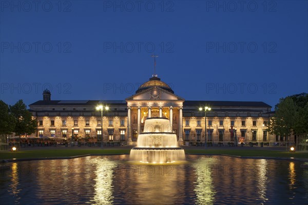 Spa hotel with fountain and park Bowling Green at dusk