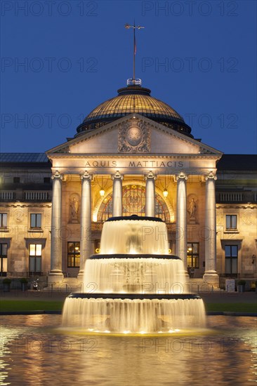 Spa hotel with fountain and park Bowling Green at dusk