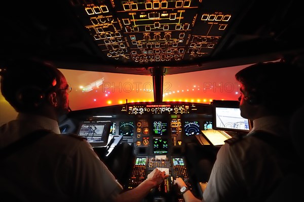 Pilot and copilot in cockpit