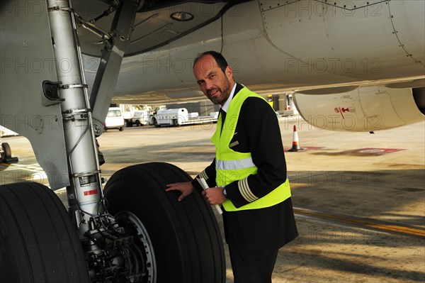 Pilot checking tyres and undercarriage